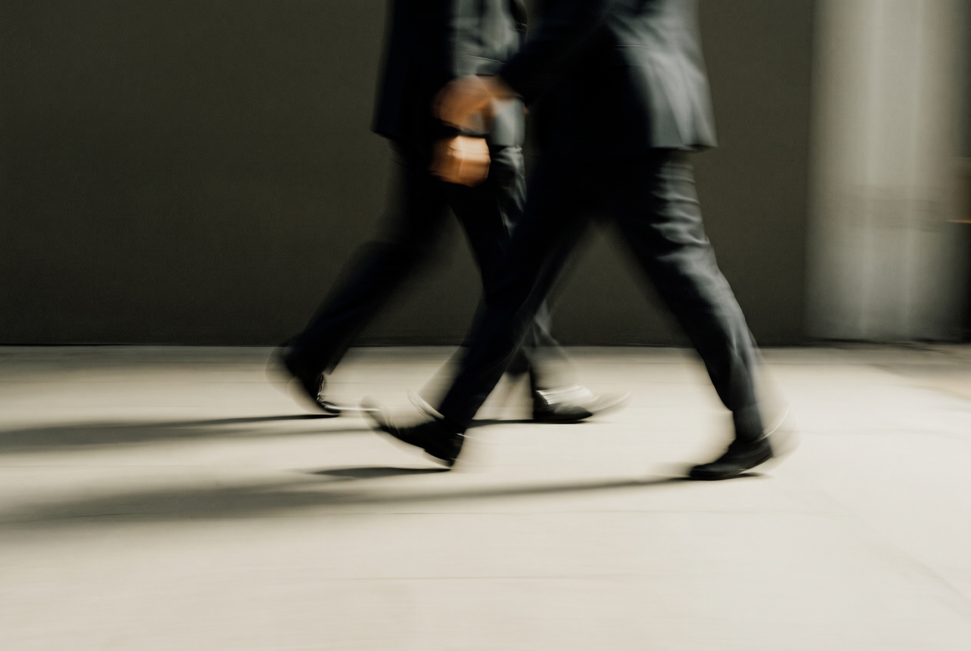 Two figures crossing in motion blur