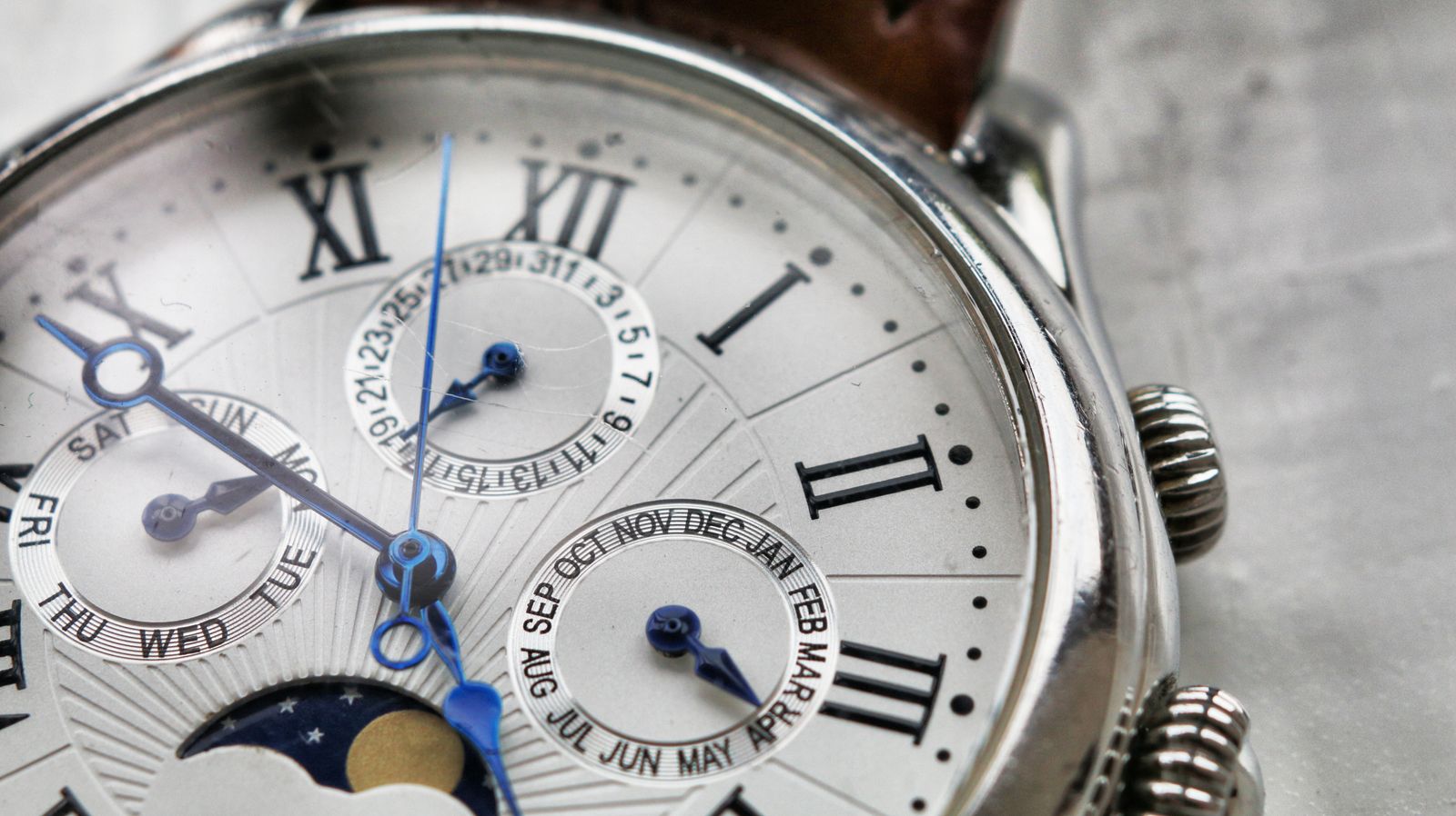 A vintage annual-calendar dial with Roman numerals and blued hands